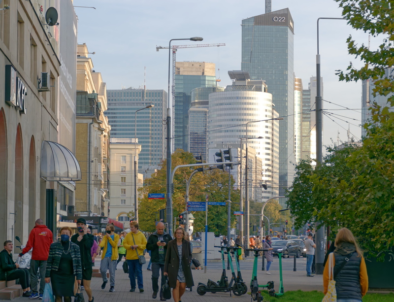 21 - A busy street scene in Warsaw, Poland, featuring the city's modern skyline in the background